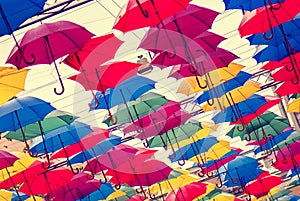 Colorful umbrellas in the air, film effects, bright spots