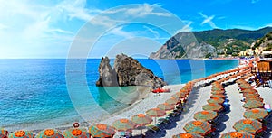 Colorful umbrellas at a beach in the Cinque Terre village of Monterosso, Italy