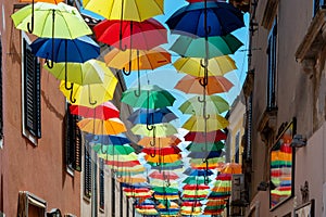 Colorful umbrellas hanging above a street