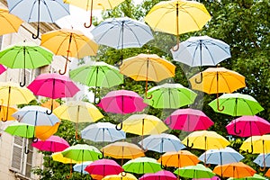 Colorful umbrellas hanging in the air.