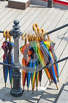 Colorful umbrellas hanging from a handrail photo