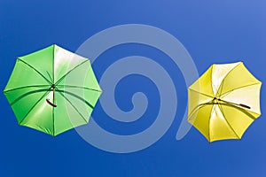 Colorful umbrellas in the sky on blue background