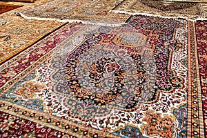 Colorful unrolled carpets in oriental marketplace