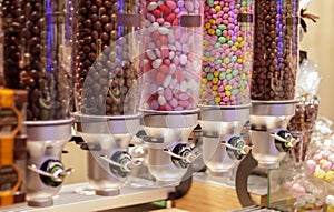 Colorful variety of fruit candies in plastic tubes in a candy store. Jelly beans for sale in the store. Colorful chewing gum balls