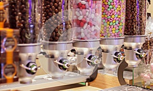 Colorful variety of fruit candies in plastic tubes in a candy store. Jelly beans for sale in the store. Colorful chewing gum balls