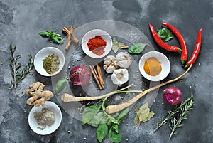 Colorful various of fresh, dried herbs and spices for cooking on a dark background