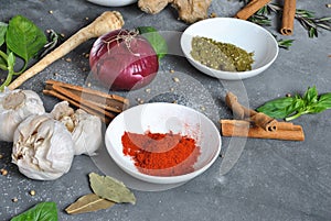 Colorful various of fresh, dried herbs and spices for cooking on a dark background