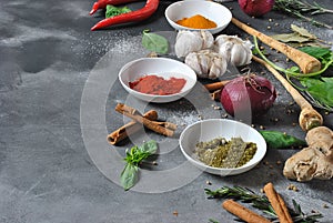 Colorful various of fresh, dried herbs and spices for cooking on a dark background