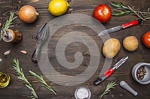 Colorful various of organic farm vegetables lemons, tomatoes, onions, potatoes, rosemary, knife cleaning potatoes place te