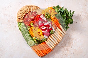 Colorful vegan Charcuterie board with raw vegetables and whole wheat snacks