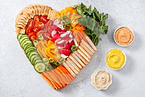 Colorful vegan Charcuterie board with raw vegetables and whole wheat snacks