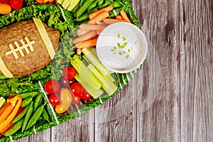 Colorful vegetable platter with meatloaf like a football ball for football watching party