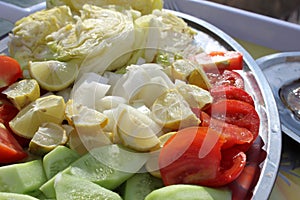 Colorful vegetables composition with red and yellow tomatoes, cucumbers, greens. Top view.