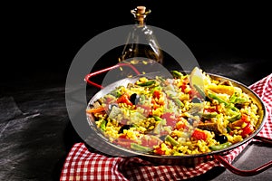 Colorful Vegetarian Spanish Paella Served with Oil