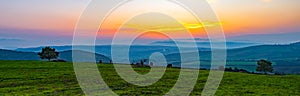 Colorful vibrant sunset, panoramic view to farm fields photo