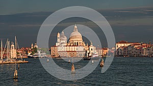 Colorful view of Basilica di Santa Maria della Salute and busy Grand Canal at sunset, Venice, Italy, summer time