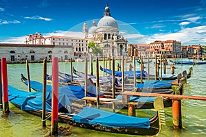 Colorful view of Basilica di Santa Maria della Salute and busy Grand Canal at sunset, Venice, Italy, summer time