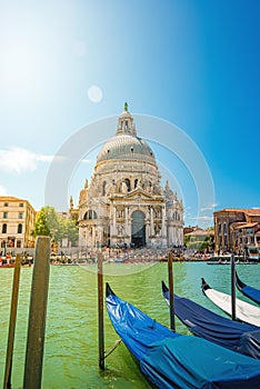 Colorful view of Basilica di Santa Maria della Salute and busy Grand Canal at sunset, Venice, Italy, summer time