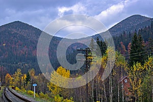 Colorful view of the slopes of wooded mountains in autumn.