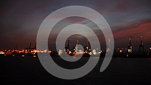 Colorful views, a play of colors at sunset. Night views of ships and piers at the port. Jeddah Port, Saudi Arabia.