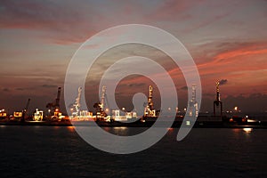 Colorful views, a play of colors at sunset. Night views of ships and piers at the port. Jeddah Port, Saudi Arabia.