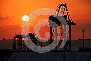 Colorful views, a play of colors at sunset. Night views of ships and piers at the port. Jeddah Port, Saudi Arabia.