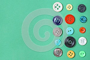 Colorful vintage buttons on green background