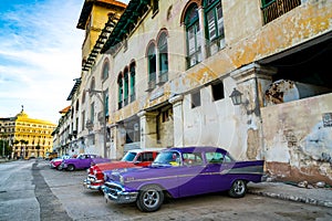 Colorful vintage Cars outside Old Building in Cuba