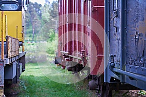 Colorful vintage railroad cars as a backdrop.