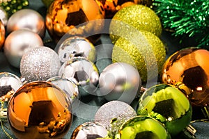 Colorful and vivid Christmas arrangement. Close Up view of Christmas golden balls with spangles and decorative wreath.