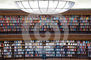 Colorful wall of books on the shelfs at the rotunda in Stockholm Stadsbibliotek or Public Library