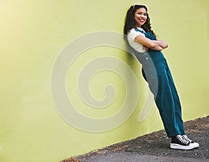 Colorful wall, mockup and fashion woman portrait in city with cool, trendy and happy attitude in urban town street