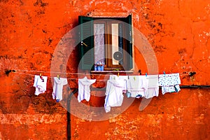 Colorful wall & window with drying clothes