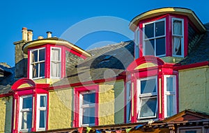 Colorful walls and windows of Tarbert historic buildings.