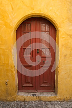Colorful walls and wooden door in Rhodes old town, Greece