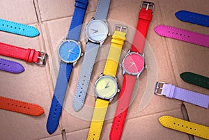 Colorful watches on cardboard background