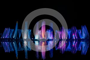 The colorful water fountain dancing in celebration festival refection color on water.