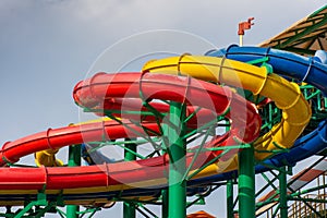 Colorful water Park twisted water slide amusement resort for luxury children and family vacations on a warm sunny tropical day