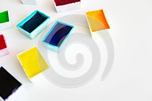 Colorful watercolor palette on white background with copy space and selective focus. Concept creative