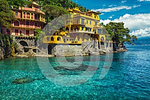 Colorful waterfront houses with beautiful azure blue beach, Portofino, Italy