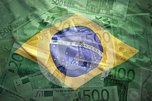 Colorful waving brazilian flag on a euro background