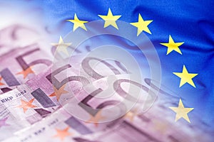 Colorful waving european union flag on a euro money background