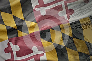 Colorful waving flag of maryland state on a american dollar money background.