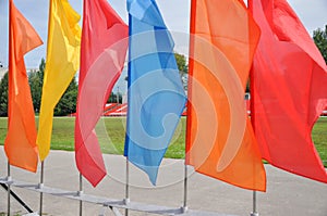 Colorful waving flags and empty seats in the stands of the arena