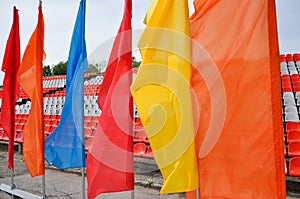 Colorful waving flags and empty seats in the stands of the arena