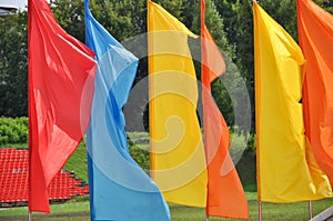 Colorful waving flags and empty seats in the stands of the arena