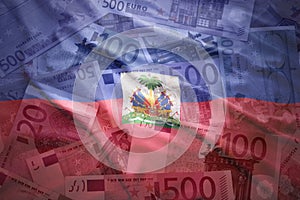 Colorful waving haitian flag on a euro background