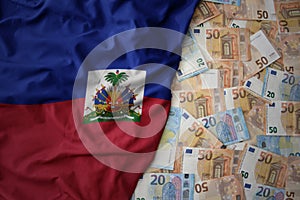 colorful waving national flag of haiti on a euro money background. finance concept