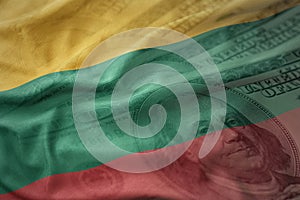 Colorful waving national flag of lithuania on a american dollar money background.