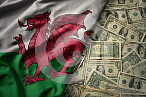 colorful waving national flag of wales on a american dollar money background. finance concept